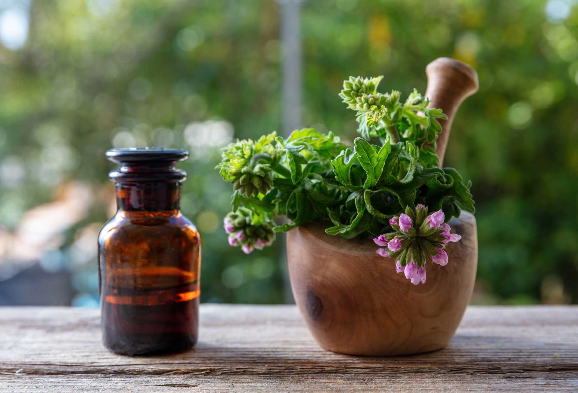 Citronella Oil Bottle next to flower